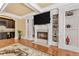 Living room with hardwood floors, fireplace, built-in shelving, and a view into the bar area at 4437 Blue Ridge Dr, Douglasville, GA 30135