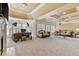 Spacious living room with neutral carpet, tray ceilings, sofas, and multiple windows at 4437 Blue Ridge Dr, Douglasville, GA 30135