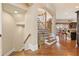 Spacious staircase with wood floors, ornate iron railing, and kitchen view at 4437 Blue Ridge Dr, Douglasville, GA 30135