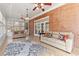 Bright sunroom featuring tile flooring, brick accent wall, and large windows at 4437 Blue Ridge Dr, Douglasville, GA 30135