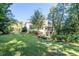 Well-maintained backyard with a large lawn and lush landscaping surrounding a classic two-story home at 515 Danube Ne Rd, Atlanta, GA 30342