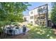 Beautiful backyard with a cozy fire pit area, surrounded by green lawn and a two-story home at 515 Danube Ne Rd, Atlanta, GA 30342