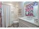 Charming bathroom with shower-tub combo, colorful wallpaper, and modern vanity at 515 Danube Ne Rd, Atlanta, GA 30342