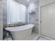 Serene bathroom with a standalone tub and marble wall at 515 Danube Ne Rd, Atlanta, GA 30342