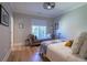 Relaxing bedroom with a daybed, natural light, and hardwood floors at 515 Danube Ne Rd, Atlanta, GA 30342