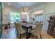 Beautiful dining room with hardwood floors, wainscotting, and a large window offering natural light at 515 Danube Ne Rd, Atlanta, GA 30342