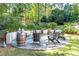 Outdoor fire pit area with chairs and barrel accents, nestled in a serene backyard setting at 515 Danube Ne Rd, Atlanta, GA 30342