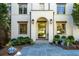 Beautiful stone walkway leading to a striking front door with manicured shrubbery and decorative pottery at 515 Danube Ne Rd, Atlanta, GA 30342