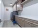 Contemporary laundry room with front-loading machines, cabinetry, and plenty of counter space at 515 Danube Ne Rd, Atlanta, GA 30342