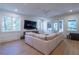 Bright living room features recessed lights, hardwood floors, large sectional couch, and large windows for ample natural light at 515 Danube Ne Rd, Atlanta, GA 30342