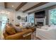Elegant living room featuring a fireplace, wood beams, and comfortable seating at 515 Danube Ne Rd, Atlanta, GA 30342