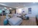 Spacious living room with light hardwood floors, a large sectional, and a glass-enclosed room on the left at 515 Danube Ne Rd, Atlanta, GA 30342
