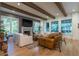 Spacious living room boasting a fireplace, exposed beams, and oversized windows offering views of the outdoors at 515 Danube Ne Rd, Atlanta, GA 30342