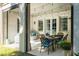 Covered patio featuring outdoor dining area, white brick pillars, and string lights for an inviting atmosphere at 515 Danube Ne Rd, Atlanta, GA 30342