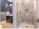 Modern bathroom shower with light tile and glass door at 515 Danube Ne Rd, Atlanta, GA 30342