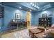 Wine room with custom storage, beverage coolers, curated art, and comfortable seating at 515 Danube Ne Rd, Atlanta, GA 30342