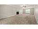 Spacious living room featuring a fireplace, neutral paint, and ample natural light from the window at 2802 Oak Meadow Ln, Snellville, GA 30078