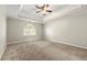 Spacious main bedroom with neutral carpet, trey ceiling, and a bright window at 2802 Oak Meadow Ln, Snellville, GA 30078
