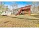 Backyard view of the house and deck with stairs, plus shed on grassy lawn at 4565 Canebrake Ct, Powder Springs, GA 30127