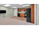 Basement kitchen features tile flooring, wood cabinets, and black appliances, providing practical and convenient amenities at 4565 Canebrake Ct, Powder Springs, GA 30127