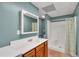 Bright bathroom with vanity, white shower and curtain; includes a vanity with traditional wood cabinets at 4565 Canebrake Ct, Powder Springs, GA 30127