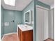 Bathroom with vanity sink, wood cabinets, framed mirror, paint color, and a closet with folding doors at 4565 Canebrake Ct, Powder Springs, GA 30127