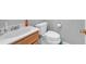 This bathroom features a white sink with wood cabinet, toilet with handicap seat riser, and roll paper holder at 4565 Canebrake Ct, Powder Springs, GA 30127