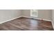 A large bedroom features wood flooring and a window for natural light, creating a cozy and inviting space at 4565 Canebrake Ct, Powder Springs, GA 30127