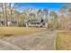 Exterior of a house with a circular driveway surrounded by a well-manicured lawn and mature trees at 4565 Canebrake Ct, Powder Springs, GA 30127