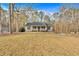 View of a single-story home with a sprawling front lawn, mature trees, and a quaint front porch at 4565 Canebrake Ct, Powder Springs, GA 30127