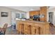 The kitchen features a breakfast bar with wooden stools, natural wood cabinets, and modern appliances at 4565 Canebrake Ct, Powder Springs, GA 30127