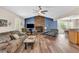 Bright living room featuring a stone fireplace, ceiling fan, wood floors, and a comfortable seating arrangement at 4565 Canebrake Ct, Powder Springs, GA 30127