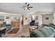 Open living area with hardwood floors, ceiling fan, and seamlessly connects to the kitchen and dining spaces at 4565 Canebrake Ct, Powder Springs, GA 30127