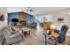 Open-concept living room featuring a stone fireplace, wood floors, and seamless access to the dining area at 4565 Canebrake Ct, Powder Springs, GA 30127