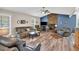 Spacious living room showcasing wood floors, comfortable furnishings, and a stone fireplace focal point at 4565 Canebrake Ct, Powder Springs, GA 30127
