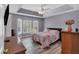 Main bedroom with trey ceilings, ample natural light, and wood-look floors at 4565 Canebrake Ct, Powder Springs, GA 30127