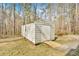 Exterior view of backyard shed with grassy lawn and trees at 4565 Canebrake Ct, Powder Springs, GA 30127