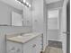 Bathroom with white vanity, sink, mirror, and tile floor at 5219 Sweet Air Ln, Stone Mountain, GA 30088