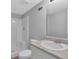 Bright bathroom featuring a white vanity with a stylish countertop and a clean, spacious shower with modern fixtures at 5219 Sweet Air Ln, Stone Mountain, GA 30088
