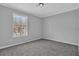 Carpeted bedroom with neutral color, large window and white molding at 5219 Sweet Air Ln, Stone Mountain, GA 30088