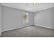 Carpeted bedroom with neutral color, large window and white molding at 5219 Sweet Air Ln, Stone Mountain, GA 30088