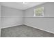 Neutral bedroom features a plush carpet and a window, offering a peaceful and comfortable retreat at 5219 Sweet Air Ln, Stone Mountain, GA 30088