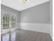 Dining room features tiled floors, white wainscoting, and French doors overlooking the outdoor area at 5219 Sweet Air Ln, Stone Mountain, GA 30088