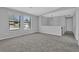 Living room with new neutral carpet, gray walls, white trim, and two windows with views of the outdoors at 5219 Sweet Air Ln, Stone Mountain, GA 30088