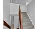 Carpeted staircase and neutral colored walls at 5219 Sweet Air Ln, Stone Mountain, GA 30088