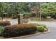 Well-maintained Dunwoody Court entrance with stone signage and manicured landscaping at 919 Dunbar Dr, Dunwoody, GA 30338
