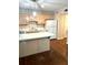 Traditional kitchen featuring white appliances, light cabinets, and an eat-in peninsula at 919 Dunbar Dr, Dunwoody, GA 30338