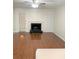 Bright living room with hardwood floors, fireplace, and a door leading to outdoor space at 919 Dunbar Dr, Dunwoody, GA 30338