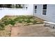Exterior view of fenced backyard with small grass patch, concrete patio, and side of home at 253 Woodland Way, Canton, GA 30114
