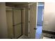 Bathroom with glass shower doors, granite counters, and open doorway at 253 Woodland Way, Canton, GA 30114
